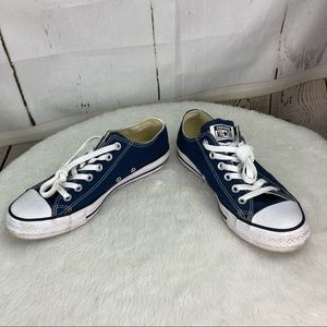 Navy blue low top Chuck Taylor sneakers